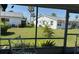 Screened lanai providing a view of a lush green yard with mature palm trees at 2218 Orange Blossom Ln # 0, Bradenton, FL 34207