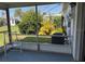 Screened lanai featuring white chairs and views of a well maintained backyard and mature shrubbery at 2218 Orange Blossom Ln # 0, Bradenton, FL 34207