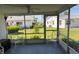 Cozy screened lanai with white chairs offering views of the well-maintained backyard at 2218 Orange Blossom Ln # 0, Bradenton, FL 34207