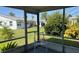Relaxing screened lanai featuring white chairs and views of a lush, green backyard at 2218 Orange Blossom Ln # 0, Bradenton, FL 34207