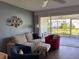 The cozy living room is furnished with a soft sofa and chairs at 2218 Orange Blossom Ln # 0, Bradenton, FL 34207