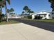 Scenic street view with palm trees and charming single-story homes and well-maintained landscaping at 2218 Orange Blossom Ln # 0, Bradenton, FL 34207