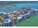 Expansive aerial view of a waterfront community with modern condos, private docks, and a scenic bay at 226 Golden Gate Pt # 63, Sarasota, FL 34236