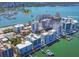 Captivating aerial view of a waterfront community with modern condos, private docks, and a scenic bay at 226 Golden Gate Pt # 63, Sarasota, FL 34236