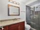 Bathroom features a modern sink with granite countertops, sleek vanity, and a tiled glass-enclosed shower at 226 Golden Gate Pt # 63, Sarasota, FL 34236