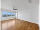 Bedroom features hardwood floors, ceiling fan, and water views at 226 Golden Gate Pt # 63, Sarasota, FL 34236