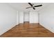 Spacious bedroom with hardwood floors and ceiling fan at 226 Golden Gate Pt # 63, Sarasota, FL 34236