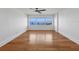 Bedroom features hardwood floors, a ceiling fan, and large windows with stunning water views at 226 Golden Gate Pt # 63, Sarasota, FL 34236