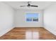 Bright bedroom boasts gleaming hardwood floors, a ceiling fan, and a large window with a picturesque bridge view at 226 Golden Gate Pt # 63, Sarasota, FL 34236