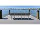 Scenic dock with a bench overlooking the tranquil waterfront and distant bridge, perfect for relaxation at 226 Golden Gate Pt # 63, Sarasota, FL 34236