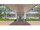 A covered entrance leads to a secure entrance, featuring a brick walkway and well maintained landscaping at 226 Golden Gate Pt # 63, Sarasota, FL 34236