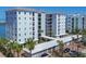 Stunning condo building featuring multiple levels, private balconies and lush landscaping with palm trees at 226 Golden Gate Pt # 63, Sarasota, FL 34236