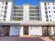 Exterior view of the condo building featuring a private entrance, beautiful brick sidewalks and lush landscaping at 226 Golden Gate Pt # 63, Sarasota, FL 34236