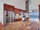 Modern kitchen with stainless steel appliances, island, custom cabinets, and amazing water views at 226 Golden Gate Pt # 63, Sarasota, FL 34236
