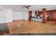 Open living area with hardwood floors, a ceiling fan, and a partial view of the kitchen at 226 Golden Gate Pt # 63, Sarasota, FL 34236