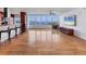 Open-concept living area with hardwood floors and panoramic windows showcasing stunning waterfront views at 226 Golden Gate Pt # 63, Sarasota, FL 34236