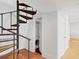 Unique spiral staircase with wood treads providing access to other floors near the laundry room with washer and dryer at 226 Golden Gate Pt # 63, Sarasota, FL 34236