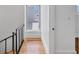 Staircase with metal railing and light wood treads leads to the upper level, flooded with natural light at 226 Golden Gate Pt # 63, Sarasota, FL 34236