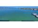 Stunning waterfront view showcasing the bridge, blue water and coastal scenery with palm trees on the coast at 226 Golden Gate Pt # 63, Sarasota, FL 34236