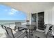 Enjoy panoramic ocean views from this balcony featuring a dining set perfect for outdoor meals and relaxation at 2425 Gulf Of Mexico Dr # 6A, Longboat Key, FL 34228