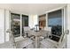 Enjoy ocean views on a spacious balcony with dining set and seamless transition to indoor living space at 2425 Gulf Of Mexico Dr # 6A, Longboat Key, FL 34228