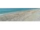 Expansive sandy beach with gentle waves lapping the shore, ideal for a peaceful stroll at 2425 Gulf Of Mexico Dr # 6A, Longboat Key, FL 34228