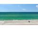 Stunning ocean view featuring crystal clear turquoise waters and a pristine sandy beach with lounge chairs at 2425 Gulf Of Mexico Dr # 6A, Longboat Key, FL 34228
