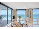 Dining area with ocean view, modern table and chairs, with a sunlit atmosphere at 2425 Gulf Of Mexico Dr # 6A, Longboat Key, FL 34228