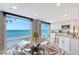 Dining area with ocean view, modern table and chairs, with a sunlit atmosphere at 2425 Gulf Of Mexico Dr # 6A, Longboat Key, FL 34228