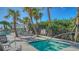 Relaxing hot tub area surrounded by lush landscaping and comfortable outdoor seating at 2425 Gulf Of Mexico Dr # 6A, Longboat Key, FL 34228