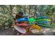 Multiple colorful kayaks on a wooded rack provide easy access for water adventures at 2425 Gulf Of Mexico Dr # 6A, Longboat Key, FL 34228