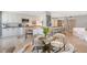 Bright kitchen and dining area featuring white cabinets, granite countertops, and stainless steel appliances at 2425 Gulf Of Mexico Dr # 6A, Longboat Key, FL 34228