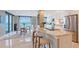 Modern kitchen with stainless steel appliances, granite countertops, and breakfast bar at 2425 Gulf Of Mexico Dr # 6A, Longboat Key, FL 34228