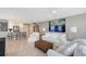 Bright, spacious living room with modern furnishings and adjacent white kitchen at 2425 Gulf Of Mexico Dr # 6A, Longboat Key, FL 34228