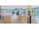 Open-concept living area with tile flooring, ocean view and comfortable white furnishings at 2425 Gulf Of Mexico Dr # 6A, Longboat Key, FL 34228