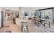 Open floor plan features a modern kitchen, dining area, and living room with access to a waterfront balcony at 2425 Gulf Of Mexico Dr # 6A, Longboat Key, FL 34228