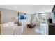 Relaxing living room features large windows with a comfortable seating arrangement at 2425 Gulf Of Mexico Dr # 6A, Longboat Key, FL 34228