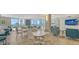 Inviting lounge area with comfortable seating, tables, and ocean views through expansive windows at 2425 Gulf Of Mexico Dr # 6A, Longboat Key, FL 34228