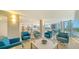 Relax in the bright lounge with stylish seating, modern decor, and expansive ocean views through large windows at 2425 Gulf Of Mexico Dr # 6A, Longboat Key, FL 34228