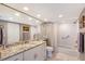 Modern main bathroom with white cabinets, granite countertops, and subway tile shower at 2425 Gulf Of Mexico Dr # 6A, Longboat Key, FL 34228