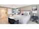 Spacious main bedroom with a seating area and en-suite bathroom, decorated in neutral colors at 2425 Gulf Of Mexico Dr # 6A, Longboat Key, FL 34228