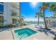 Relaxing spa next to the community pool with ocean views and seating area at 2425 Gulf Of Mexico Dr # 6A, Longboat Key, FL 34228