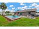 Spacious backyard with a swimming pool, patio area, and manicured lawn for outdoor enjoyment at 2522 51St Street E Ct, Palmetto, FL 34221