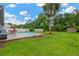 Well-maintained backyard featuring a pool, lush lawn, mature palm tree, and storage shed at 2522 51St Street E Ct, Palmetto, FL 34221