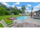 Tranquil backyard featuring a pool, patio, seating area, and lush landscaping, ideal for relaxation at 2522 51St Street E Ct, Palmetto, FL 34221