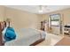 Bedroom with wood floors, a window overlooking the backyard, and neutral walls at 2522 51St Street E Ct, Palmetto, FL 34221