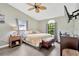 Bedroom with neutral walls, ceiling fan, and a large window with backyard views at 2522 51St Street E Ct, Palmetto, FL 34221