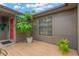 Charming front porch with brick pavers, potted plants, and a vibrant red front door at 2522 51St Street E Ct, Palmetto, FL 34221