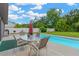 Relaxing poolside patio with a table and chairs, perfect for outdoor gatherings and enjoying the view at 2522 51St Street E Ct, Palmetto, FL 34221