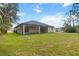 Spacious backyard with covered patio and lush lawn at 2704 Gaspar Ave, North Port, FL 34288
